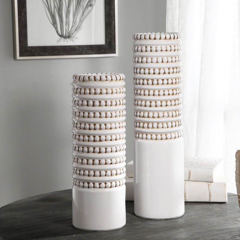 Set of two white Angelou vases by Uttermost, featuring elegant ceramic design perfect for decorative display.