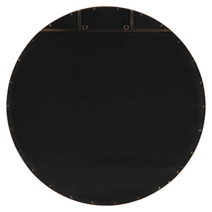 Uttermost Junius round wall mirror with a sleek frame, hanging on a wall, showcasing modern home decor.