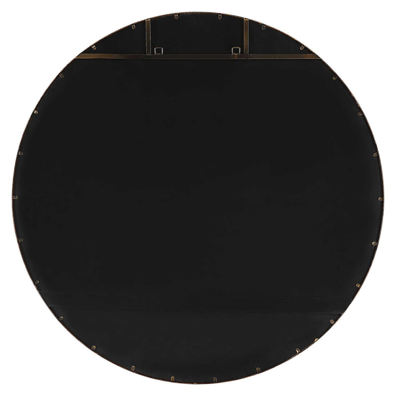 Uttermost Junius round wall mirror with a sleek frame, hanging on a wall, showcasing modern home decor.