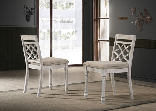 Set of two Lilola Home Havanna wide chairs with off-white cushions, featuring modern design and sturdy wooden legs.