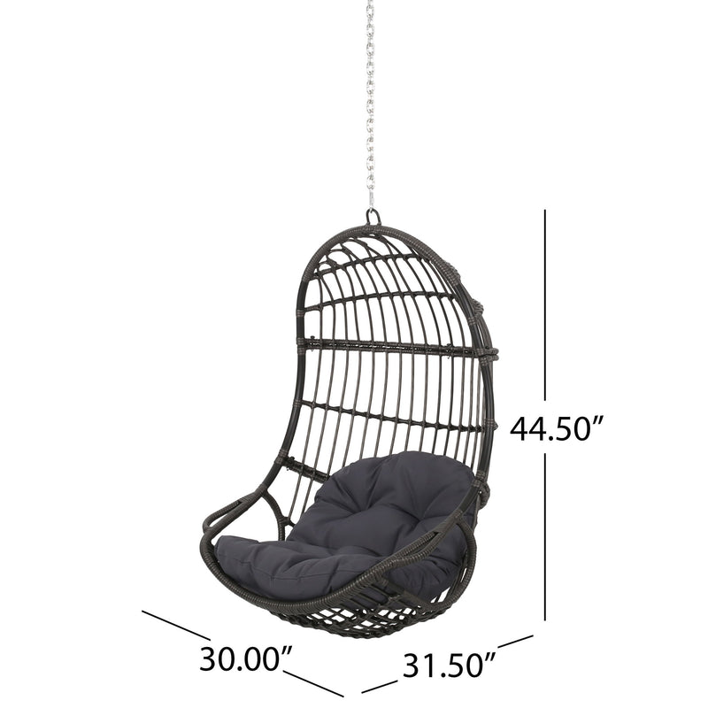 Rustic hanging basket chair with cushion by Noble House, showcasing a cozy outdoor lounge seat with woven wicker design.