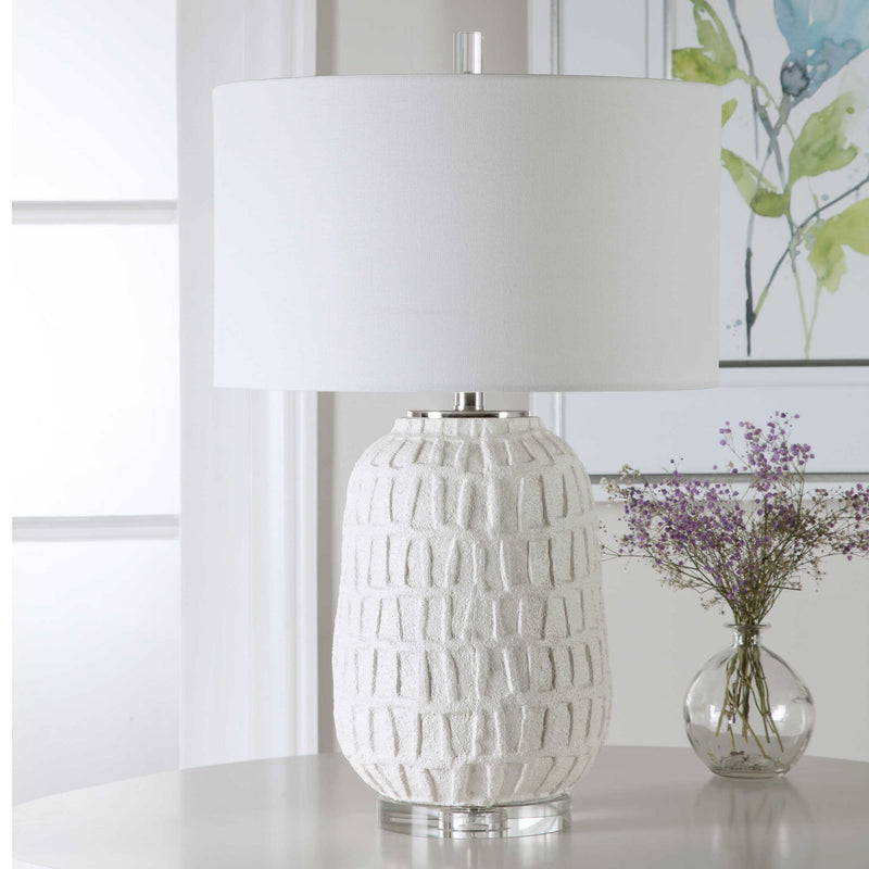 Uttermost Caelina textured white table lamp with a modern design, featuring a sleek base and fabric shade for stylish illumination.