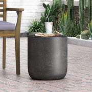 Outdoor concrete end table with natural texture and matte black finish, ideal for patio or garden spaces.