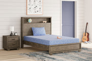 Blue Sierra Sleep® Ikidz Ocean twin size memory foam mattress and pillow set of 2 on a bed with bedding.