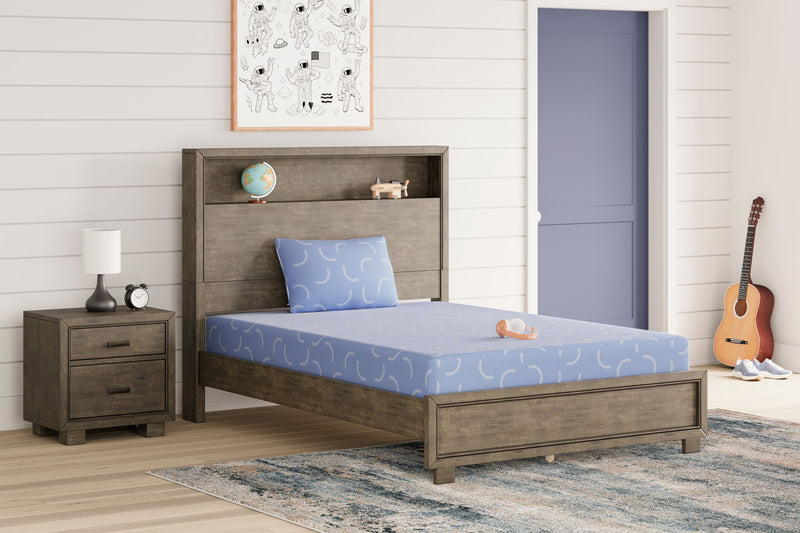 Blue Sierra Sleep® Ikidz Ocean twin size memory foam mattress and pillow set of 2 on a bed with bedding.