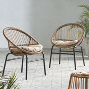 Set of two Noble House outdoor accent chairs with curved backrests and basket frames in light brown and beige.