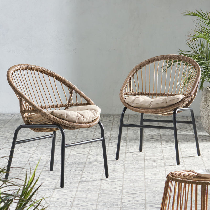 Set of two Noble House outdoor accent chairs with curved backrests and basket frames in light brown and beige.
