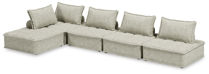 Signature Design by Ashley stationary sectional sofa with plush cushions and modern design, shown in a living room setting.