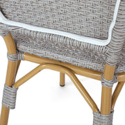 Set of two Noble House outdoor rattan and aluminum armless French bistro chairs in dark gray for patio or garden seating.