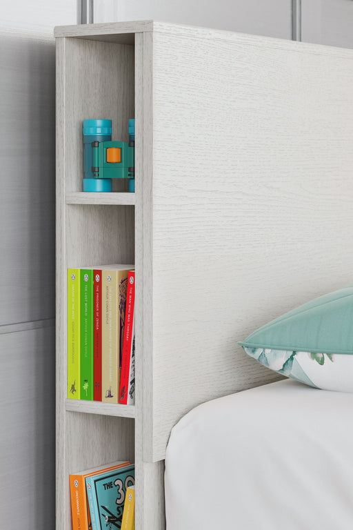 Signature Design by Ashley Aprilyn bookcase headboard with built-in shelves and a dark wood finish for bedroom storage and style.
