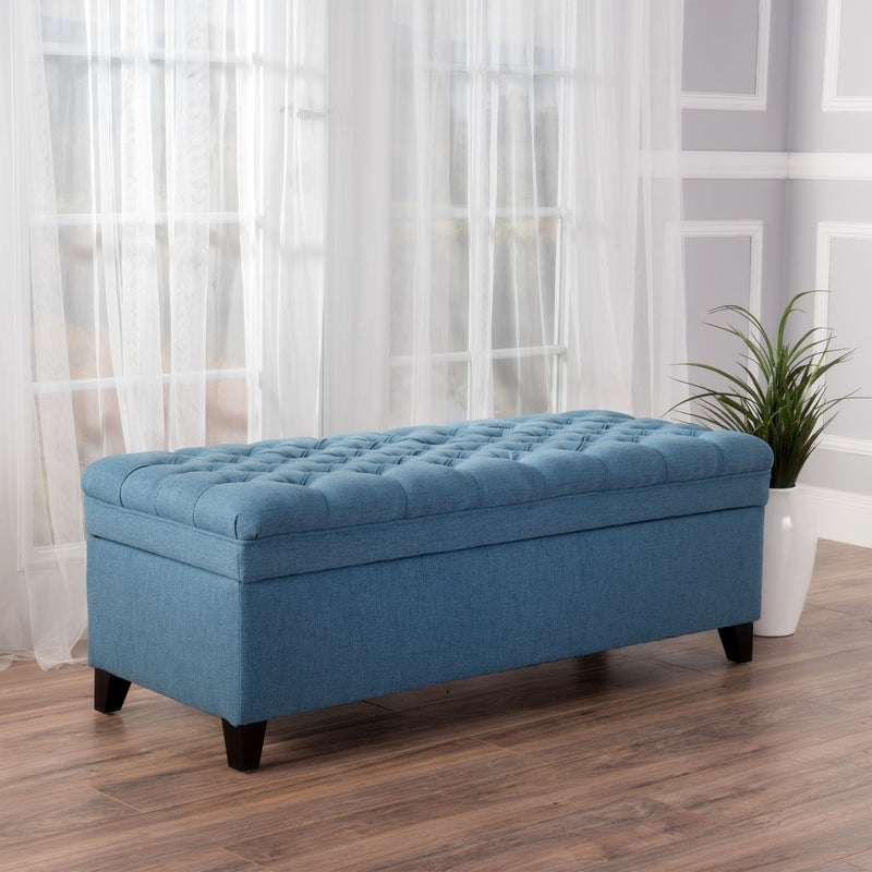Noble House Juliana storage ottoman with beige upholstery and birch wood legs, showcasing a plush cushioned top and spacious interior.