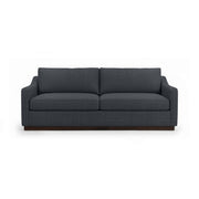 Classic Home Aspen stationary sofa with plush beige upholstery and stylish tufted backrest in a cozy living room setting.