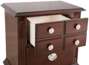 Glory Furniture Summit Cappuccino accent nightstand with a single drawer and sleek modern design, placed beside a bed.