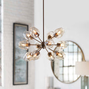 Uttermost Chet 12 Light Sputnik chandelier with light brown finish, featuring a modern geometric design and multiple exposed bulbs.