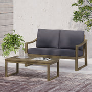 Noble House Samwell outdoor 2-piece coffee table and loveseat set with weather-resistant cushions and modern design.