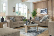 Benchcraft® Olten living room set with stationary chair and ottoman, featuring plush upholstery and modern design.