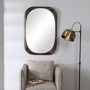 Sheldon mid-century dark brown wall mirror by Uttermost with a sleek wooden frame and modern design.