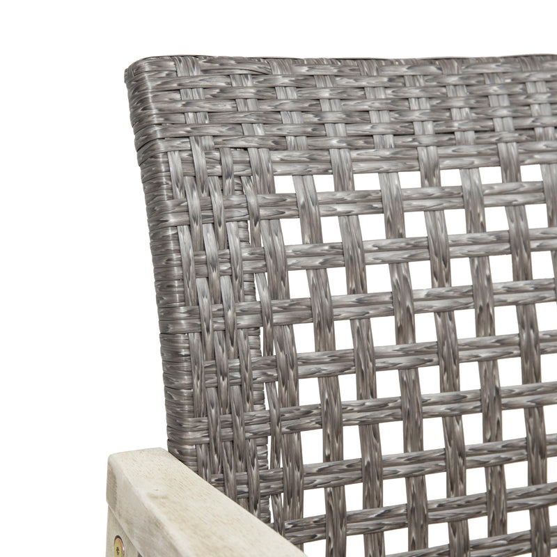 Set of two Noble House outdoor dining chairs with acacia wood frames, featuring slatted seats and armrests for garden or patio use.