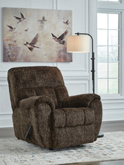 Signature Design by Ashley Stayfish rocker recliner with plush upholstery and wooden base, designed for comfort and style.