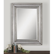 Uttermost Seymour wall mirror with an antique silver finish, showcasing a stylish round frame and beveled glass.