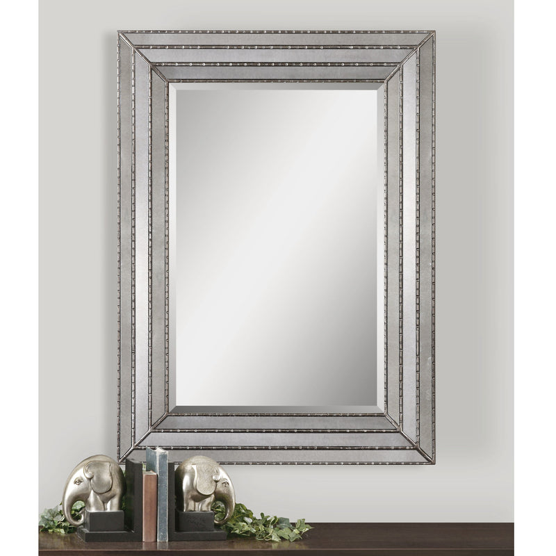 Uttermost Seymour wall mirror with an antique silver finish, showcasing a stylish round frame and beveled glass.