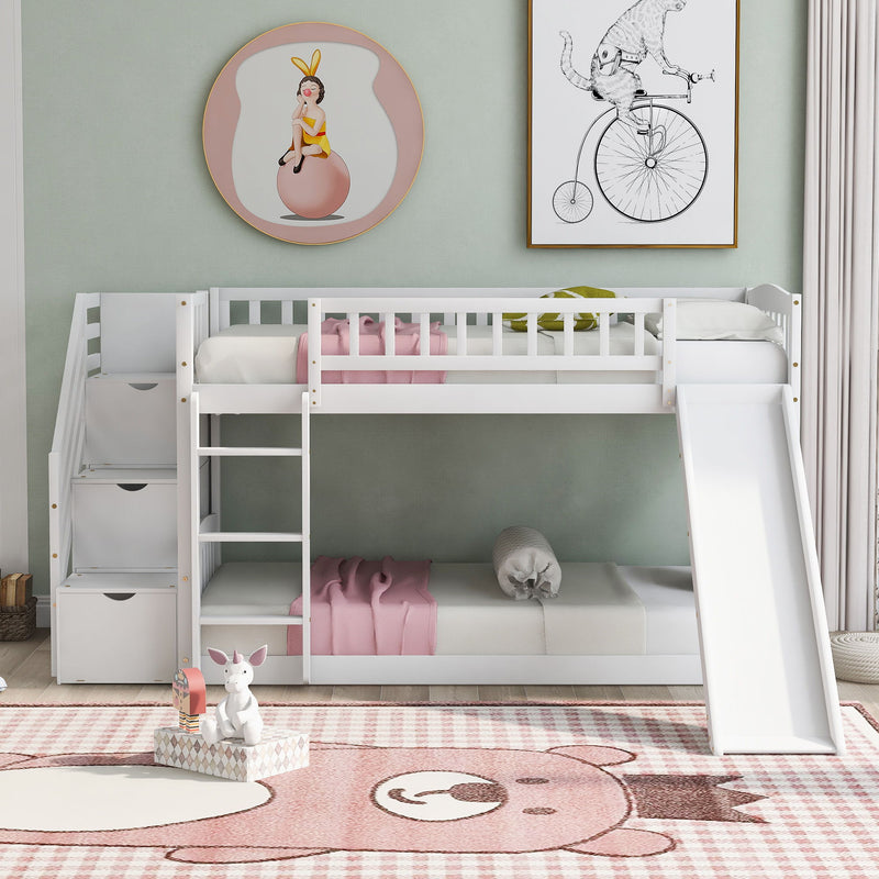 DreamHaus twin over twin stairway bunk bed with slide and two storage drawers, featuring a sturdy wooden frame and safety rails.