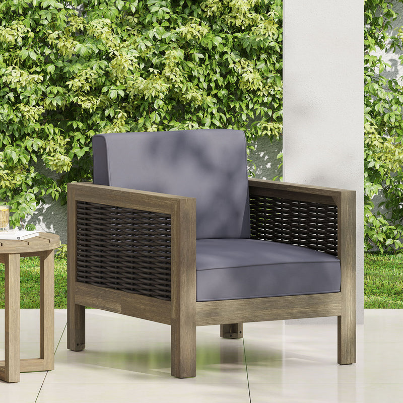Noble House outdoor acacia wood club arm chair with woven wicker accents, ideal for patio or garden seating.