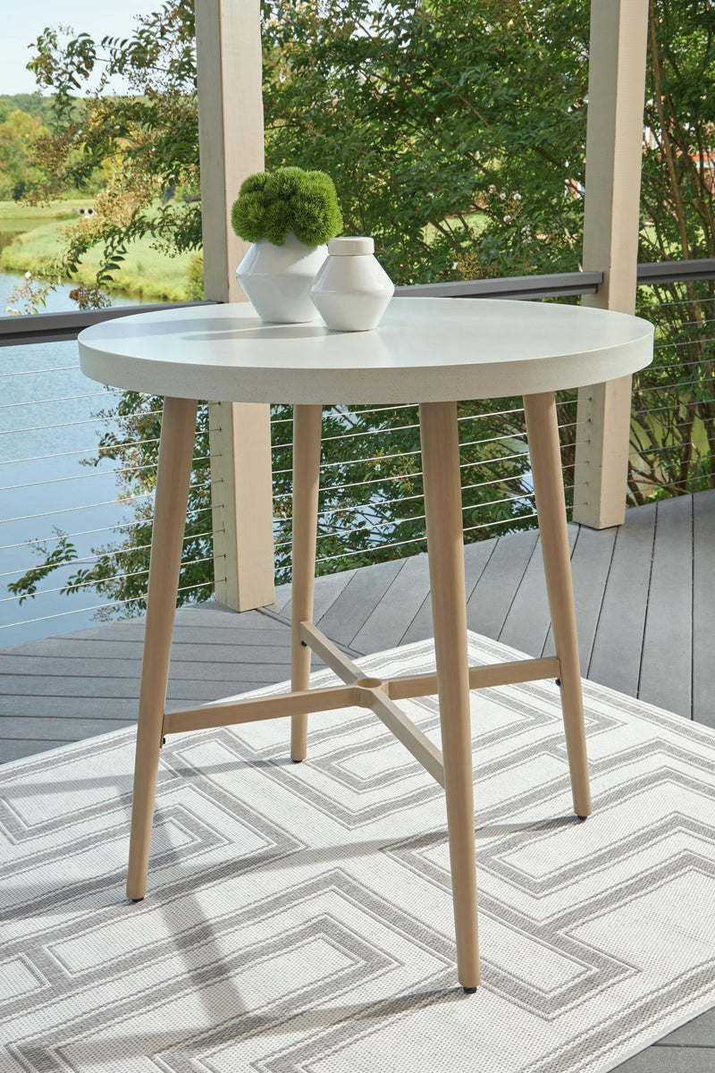 Seton Creek beige round bar table with umbrella option from Signature Design by Ashley, featuring a sturdy tabletop and stylish design.