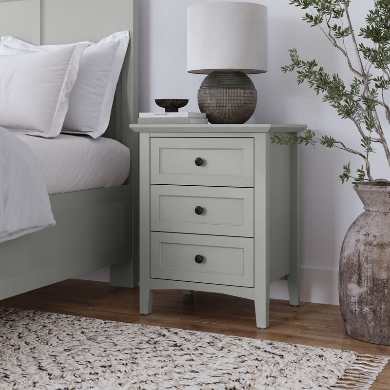 Modus Grace three-drawer nightstand in Elephant Grey with sleek design and modern hardware, shown in a bedroom setting.