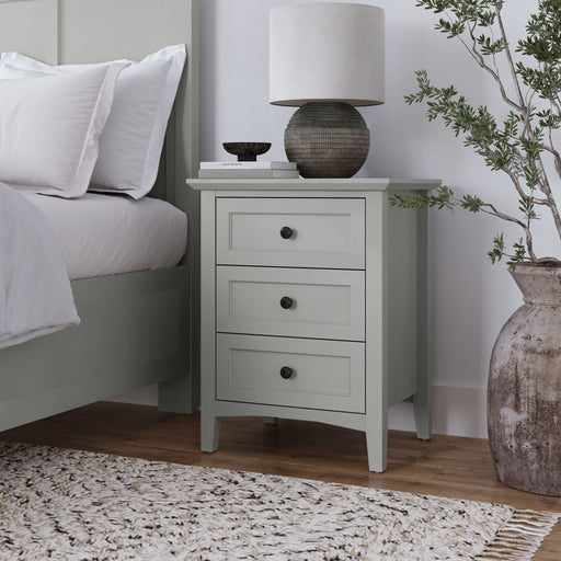 Modus Grace three-drawer nightstand in Elephant Grey with sleek design and modern hardware, shown in a bedroom setting.