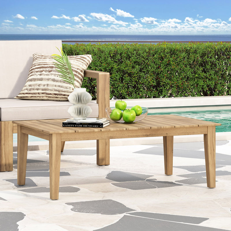 Noble House outdoor coffee table with slat panel top, light brown wood finish, sturdy design perfect for patio or garden spaces.