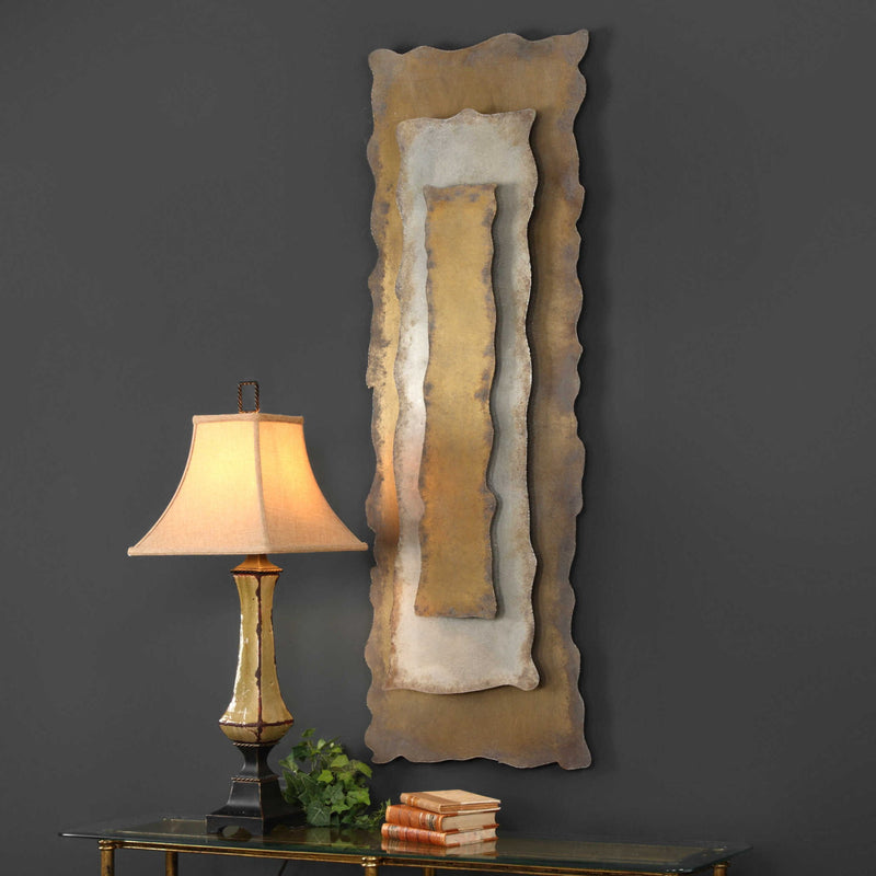Uttermost Jaymes oxidized gold wall decor panel with intricate metal design for modern interior decoration.