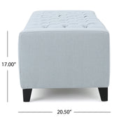 Noble House Guernsey storage ottoman with tufted top, beige fabric, and wooden legs, serving as a stylish storage and seating solution.