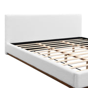 Elegant Noble House boucle upholstered bed with wood grain textured solid wood base frame, showcasing plush fabric and sturdy construction.