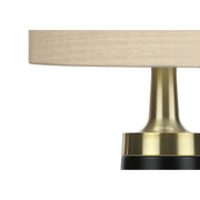 Contemporary black and cream resin table lamp from 8th Street, featuring a sleek, modern design with a cylindrical shape.