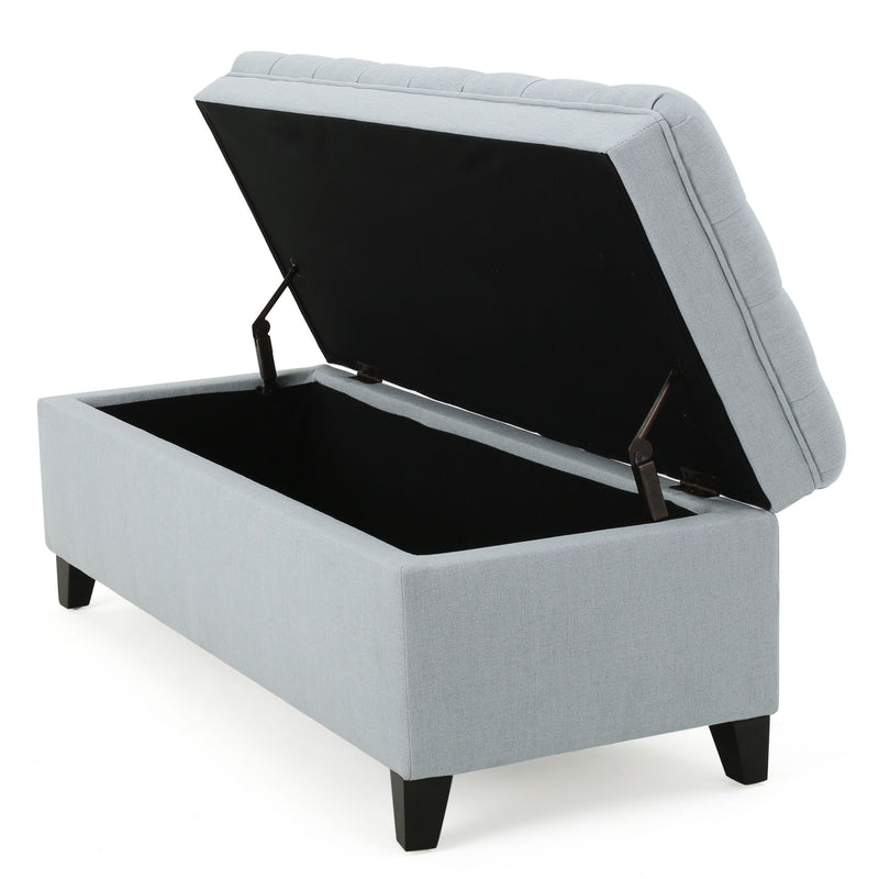 Noble House Juliana storage ottoman with birch wooden legs, beige fabric upholstery, and ample storage space.