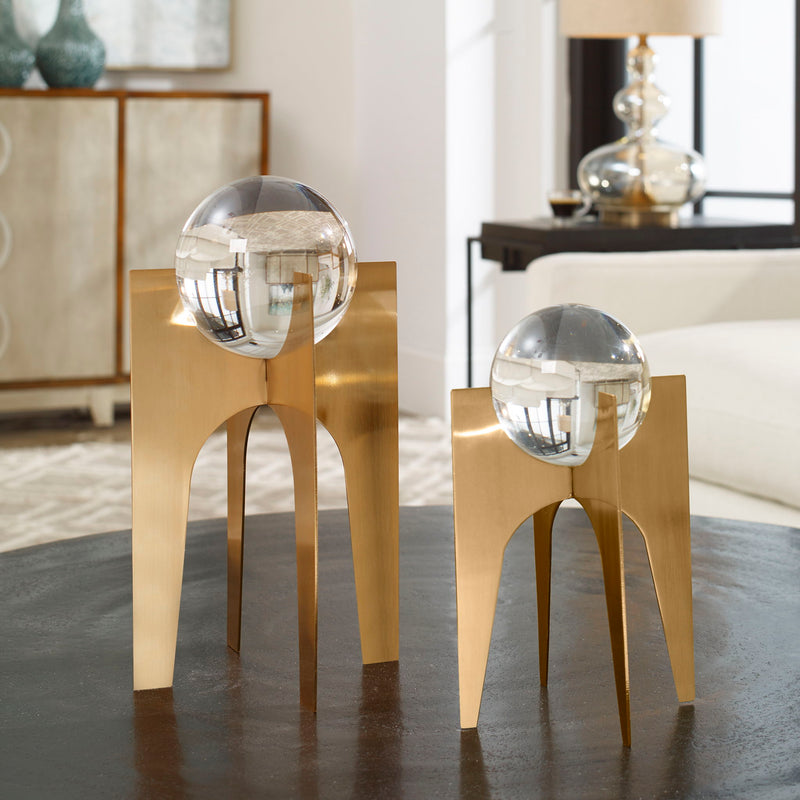 Uttermost Ellianna crystal spheres table accessory set with two elegant glass spheres on a sleek surface.