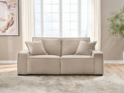 Benchcraft® Carceri reclining sectional with plush cushions and reclining seats, shown in a modern living room setting.