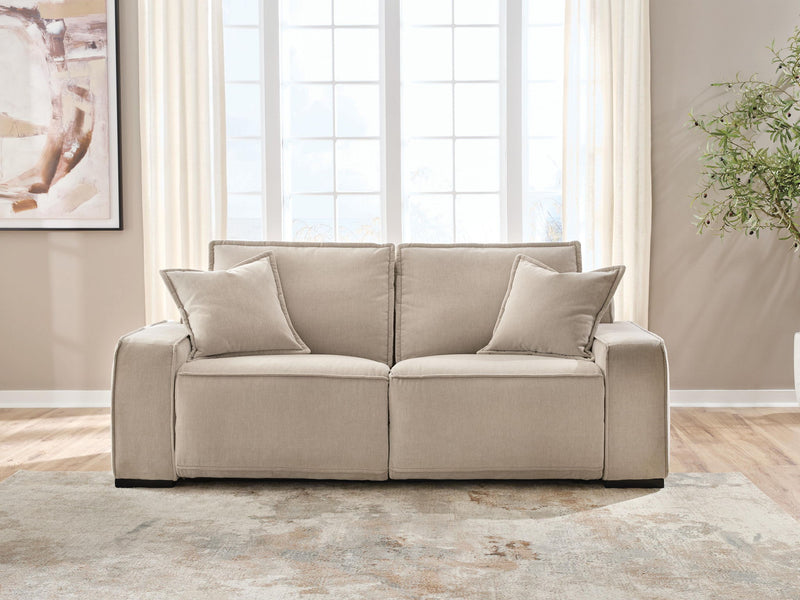 Benchcraft® Carceri reclining sectional with plush cushions and reclining seats, shown in a modern living room setting.