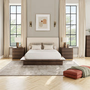 ACME Zoey upholstered bed with a padded headboard and fabric frame, shown in a modern bedroom setting.
