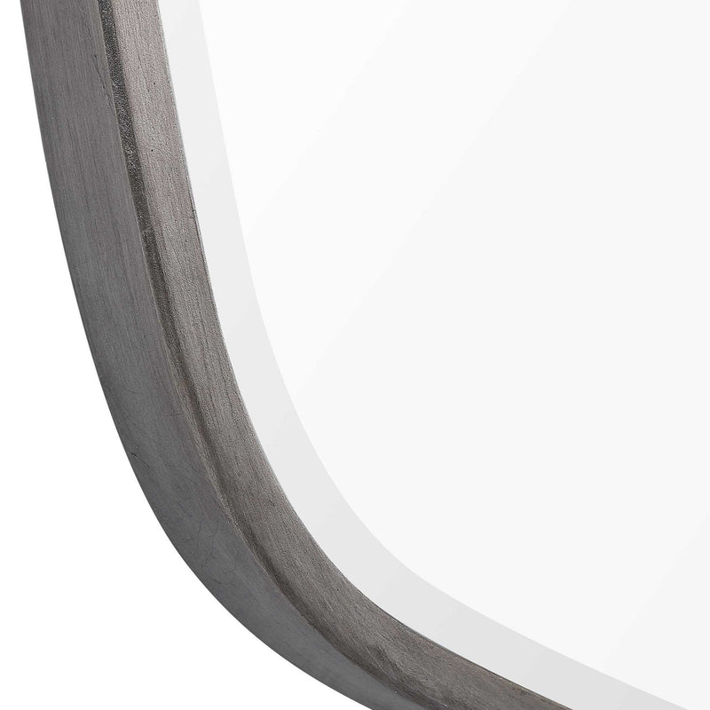Uttermost Duronia iron wall mirror with a sleek, modern frame, hanging on a neutral-colored wall.