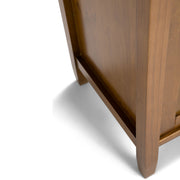 Handcrafted Warm Shaker TV media stand by Simpli-Home with open shelving and storage compartments, made of warm-toned wood.