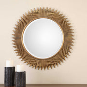 Round gold wall mirror by Uttermost, featuring a sleek, modern design with a polished gold finish.