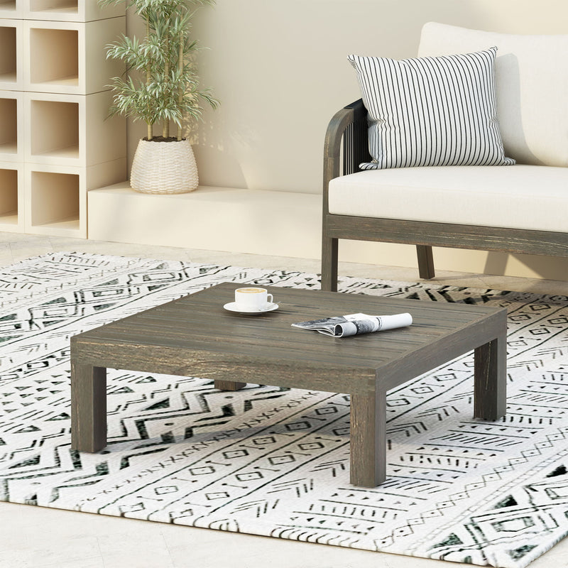 Noble House Oana Brava rustic gray coffee table with slat panel design, wooden legs and sturdy construction.