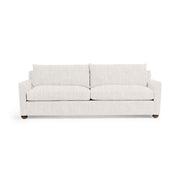 Olivia stationary sofa by Classic Home with plush beige upholstery and tufted backrest, placed in a modern living room setting.