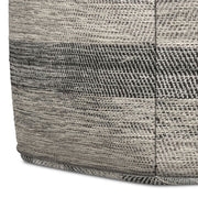 Upholstered square clay-colored accent pouf by Simpli-Home, showcasing its soft fabric and versatile seating or footrest design.