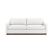 Classic Home Aspen stationary sofa with plush fabric, rolled arms, and cushioned seat in a cozy living room setting.