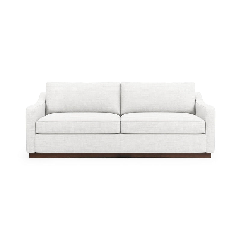Classic Home Aspen stationary sofa with plush fabric, rolled arms, and cushioned seat in a cozy living room setting.