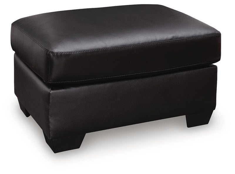 Midnight upholstered ottoman from the Glennbre collection by Signature Design by Ashley®, featuring plush fabric and modern style.