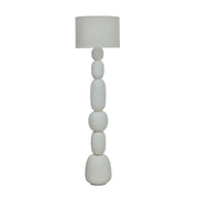 TOV Furniture Pebble Papier Mache Table Lamp with rounded pebble design and neutral finish on a wooden surface.